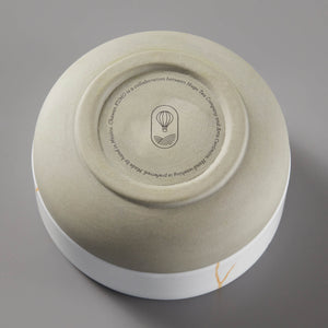 KUMO Matcha Bowl in white ceramic with gold accent, showing bottom view with brand logo and circular text design