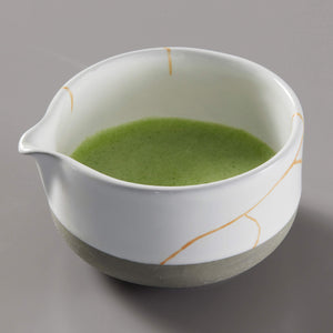 Matcha Bowl KUMO with bright green tea inside white ceramic bowl featuring gold streaks and unglazed base