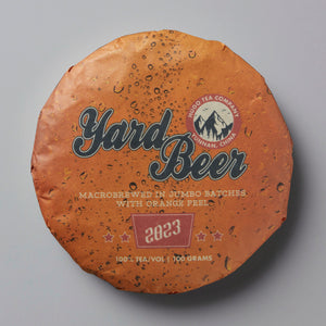 2023 Yard Beer tea cake with orange textured wrapper and mountain logo on terracotta colored packaging