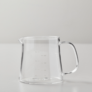 BOLI glass teapot with measurement markings, wide base, and ergonomic handle on minimalist gray background