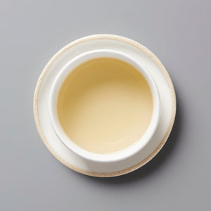 Nepal Prathama white tea in ceramic cup, showing pale golden liquor from above view