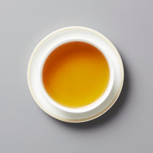 2020 Not From Concentrate white tea served in traditional white ceramic cup showing golden amber liquid color
