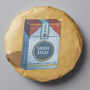 Smoke Break black tea cake with vintage cigarette pack design on yellow wrapper, pressed Chinese lapsang souchong tea