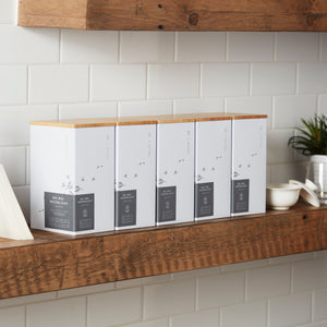 Storage Can MIYABI white tea tins with bamboo lids displayed on wooden shelf against white tile wall