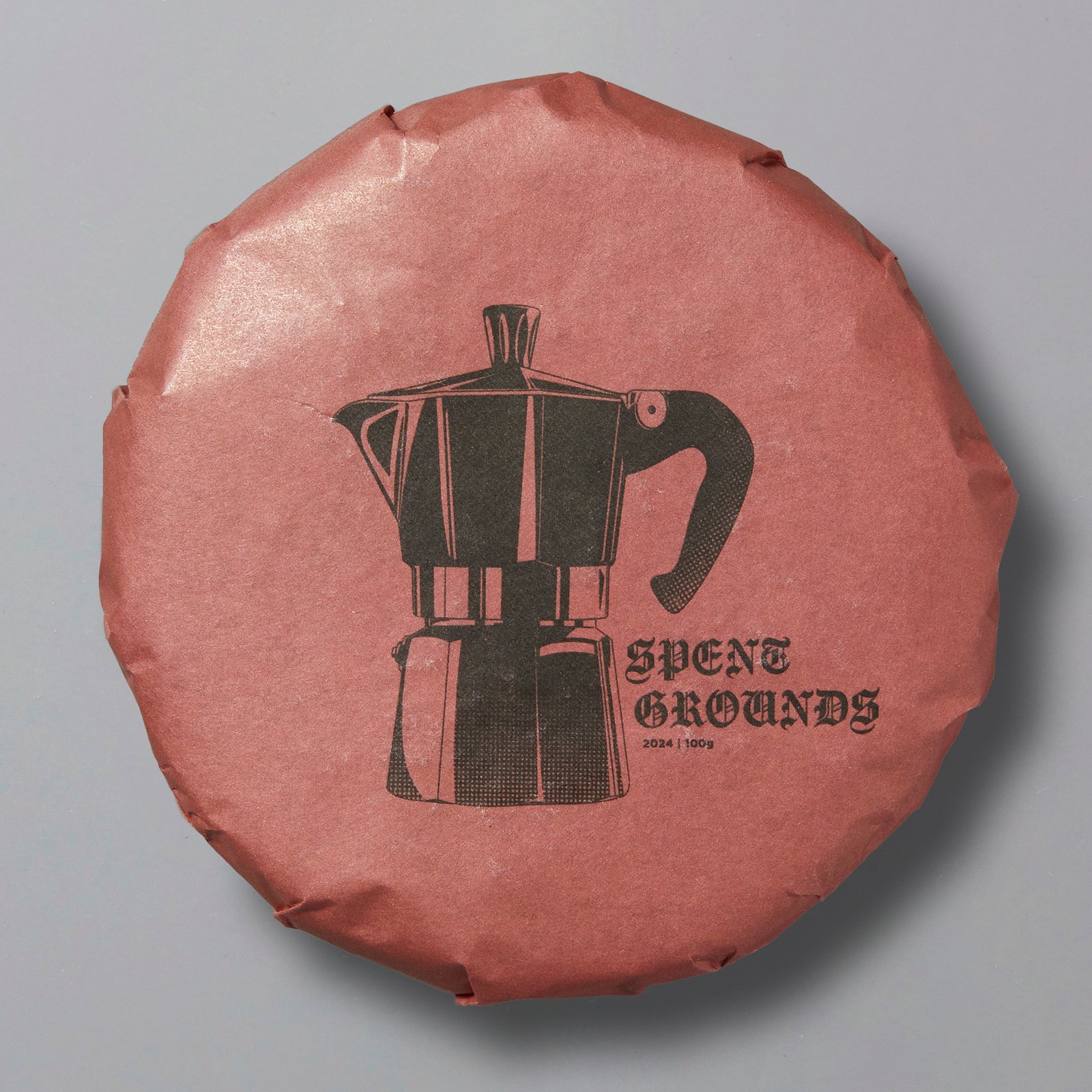 Packaged shou pu'er tea with a graphic of a coffee maker and the brand name 'Spent Grounds' on the top.