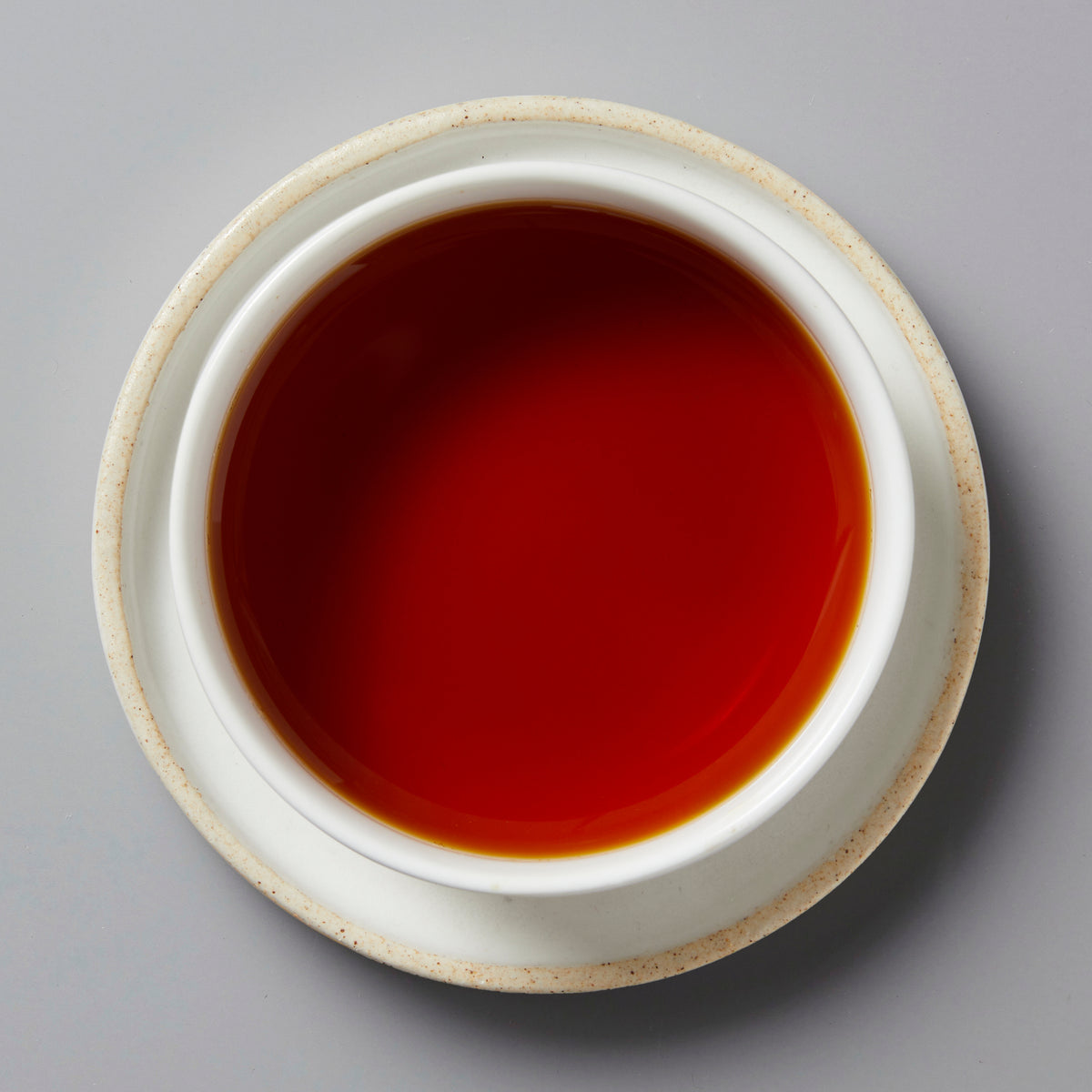 Top view of a cup filled with golden bud black tea, Tree Sap 2024, from Lincang, Yunnan, China.