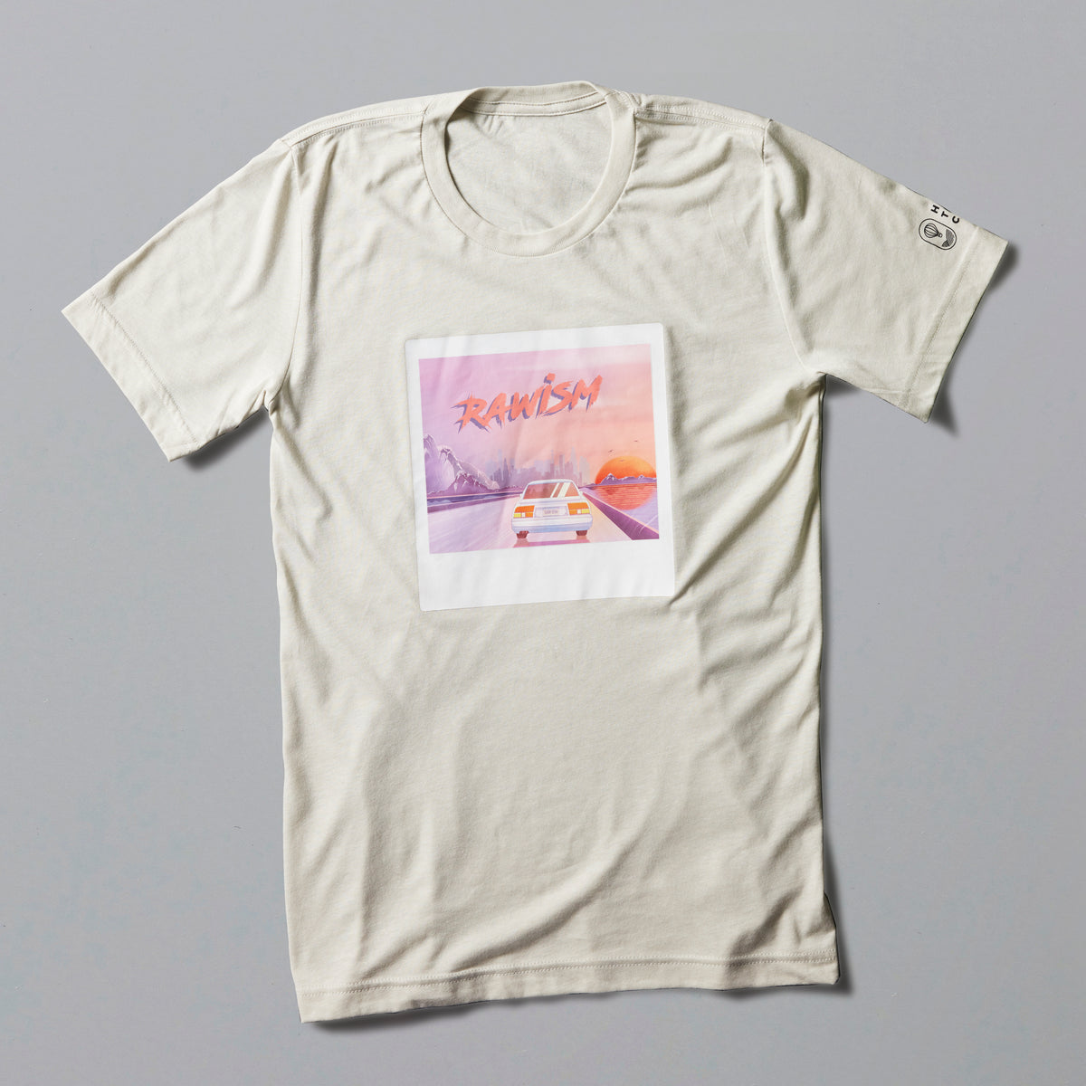 RAWISM Tee in off-white featuring retro sunset artwork with car illustration in pastel pink and orange tones