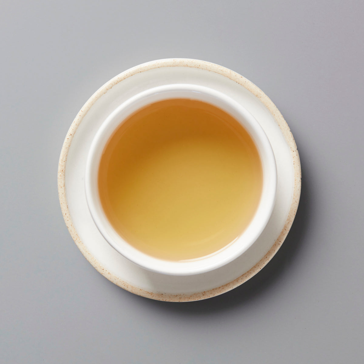 ZI RAN RED black tea from Tongmu in white ceramic cup showing amber-colored liquor against grey background
