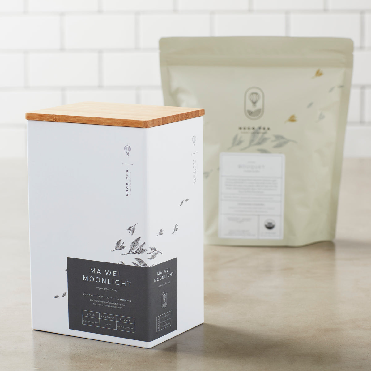 Storage Can MIYABI elegant white tin container with bamboo lid and minimalist tea packaging design on countertop