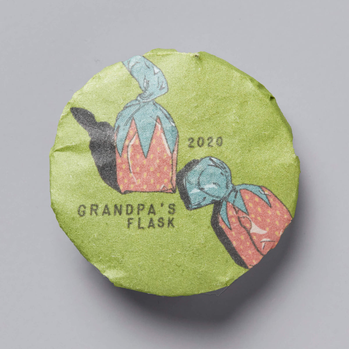 Grandpas Flask 2020 huangpian puer tea cake with illustrated flask design on green wrapper