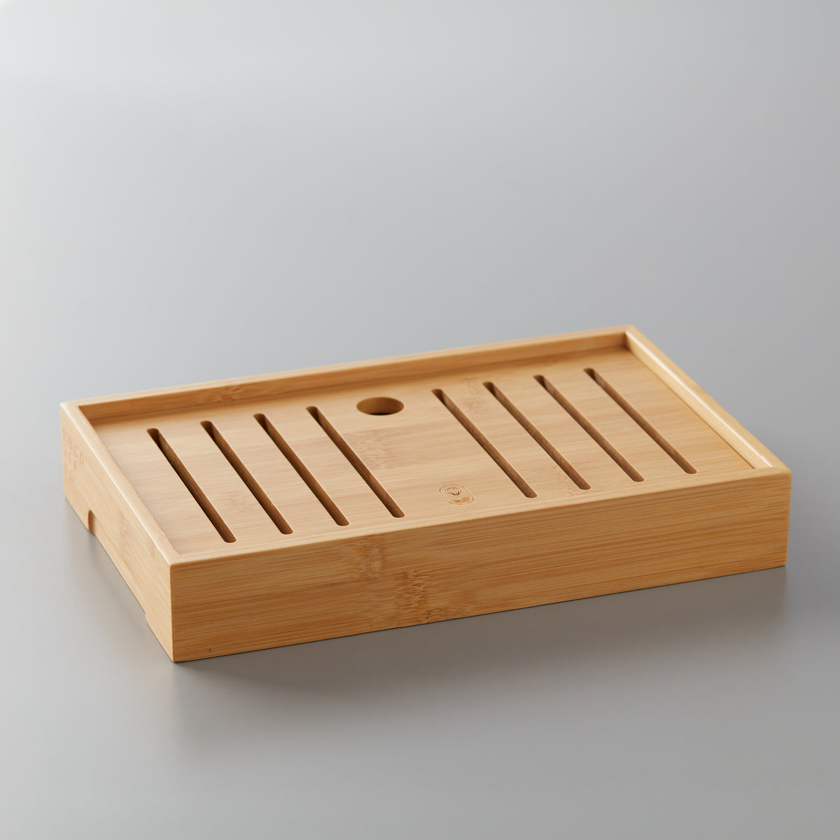Bamboo tea board tray with drainage slots designed for small-format gongfu tea steeping ceremonies.