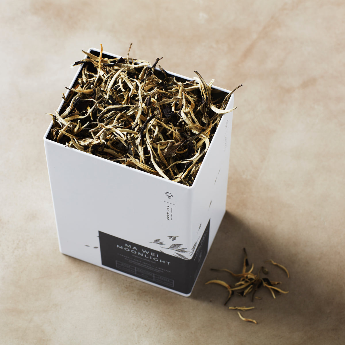 Storage Can MIYABI with dried tea leaves in white container on beige surface, showing product packaging and contents